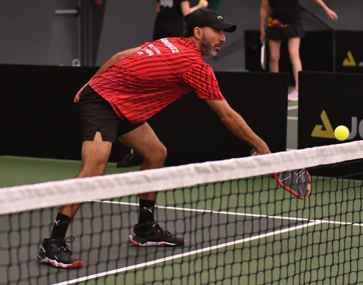 Izaak Gonzalez stretching for a low ball